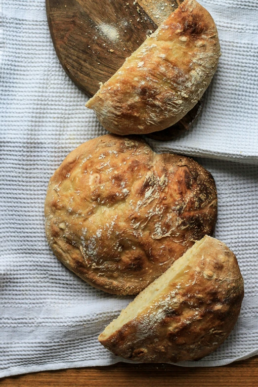 this is three large loaves of bread on a towel