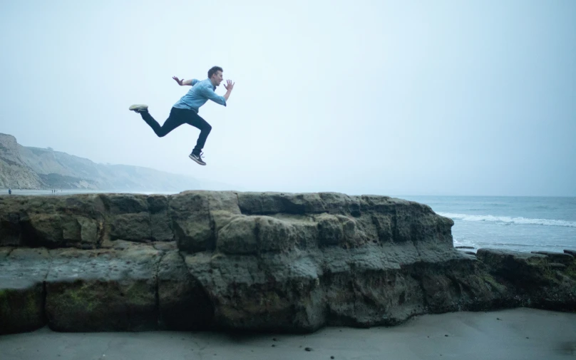 a man flying through the air while riding a skateboard