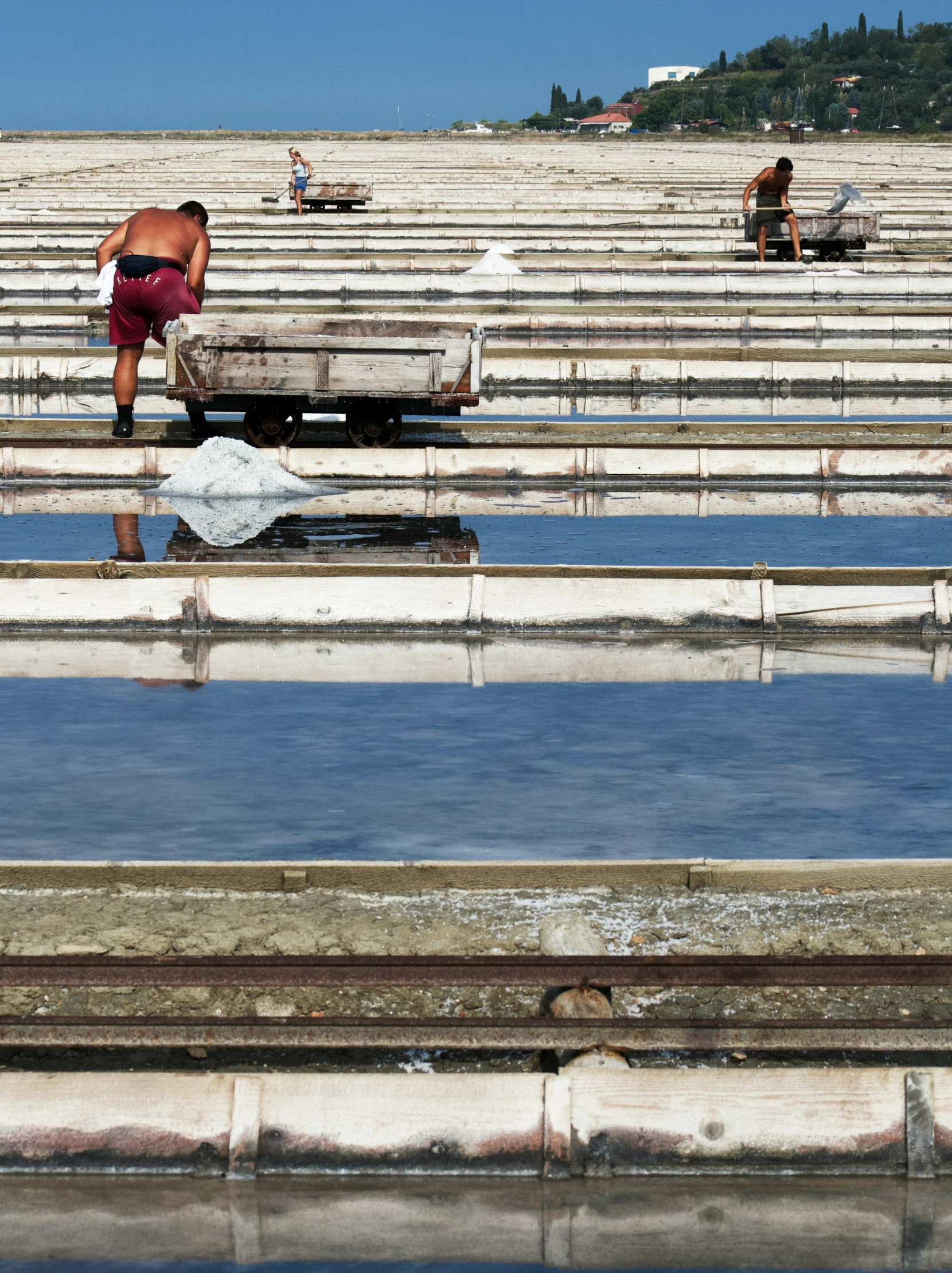 some people standing in a flooded stadium by a bench