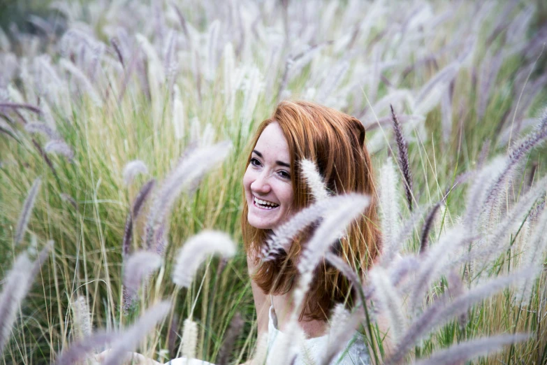 an image of a woman standing in tall grass