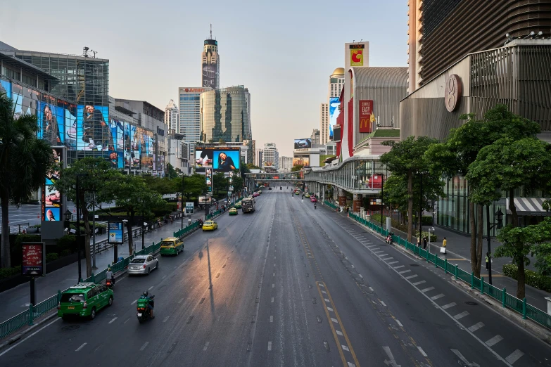 a city street at dusk with cars on it