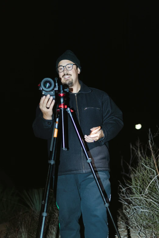 a man with a camera and tripod taking a picture