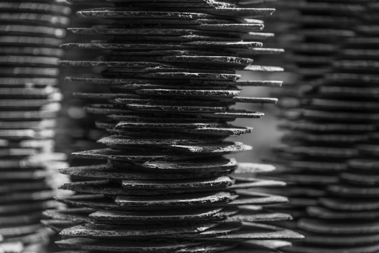 stacked objects in a room with black and white pography