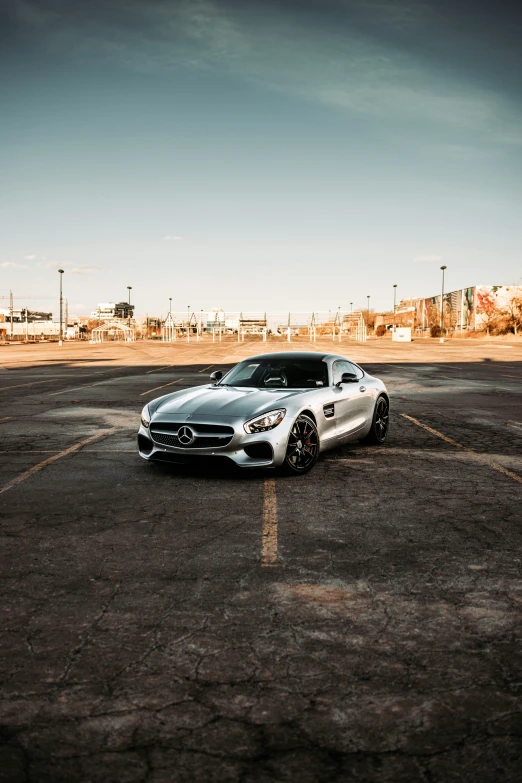 the silver car is in a parking lot