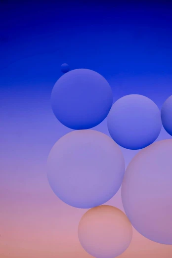 an image of three bubbles in a surreal blue sky