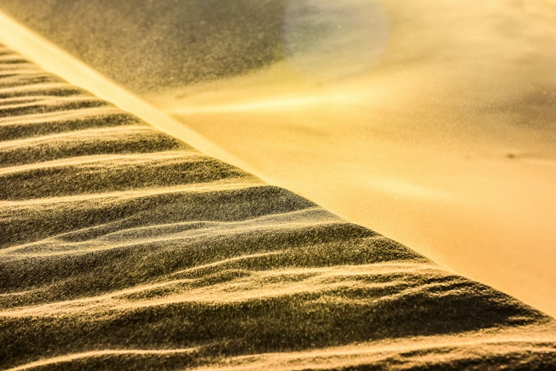 a close up of sand being blown by the wind