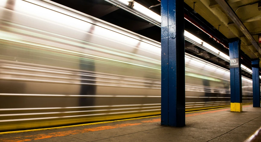 a train in motion moving past another building