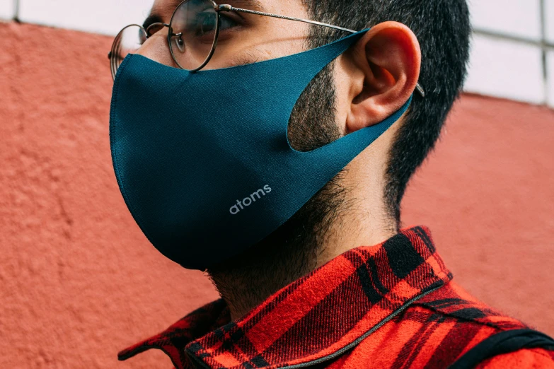 man wearing a mask standing outside with glasses