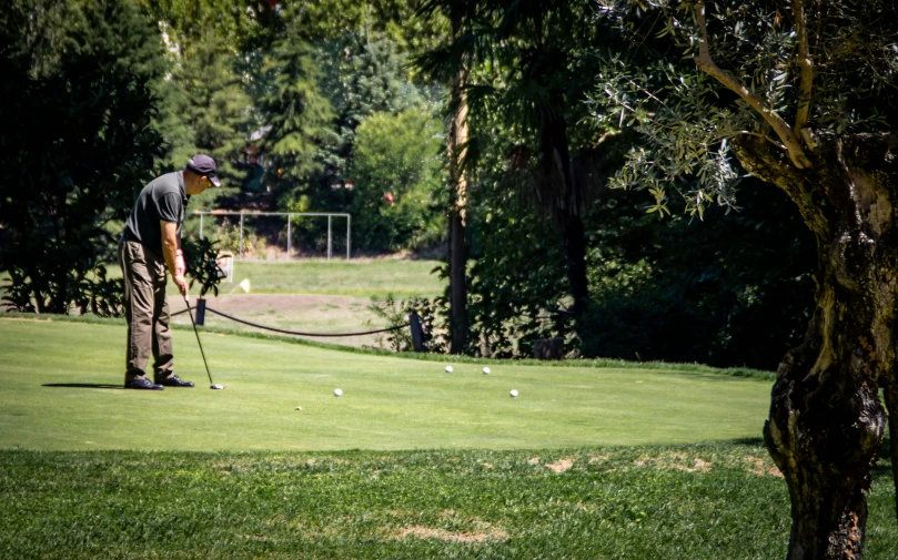 a man is putting golf balls into his cart