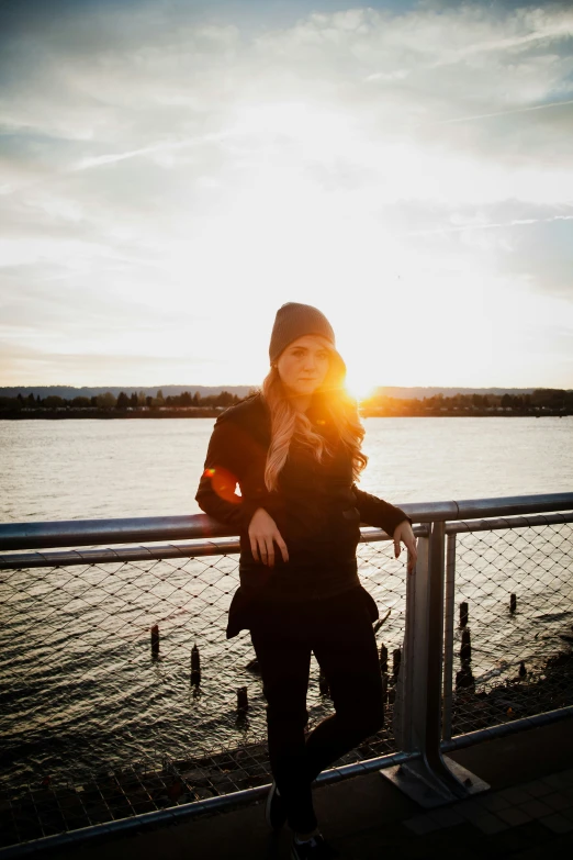 a young woman is standing near a railing