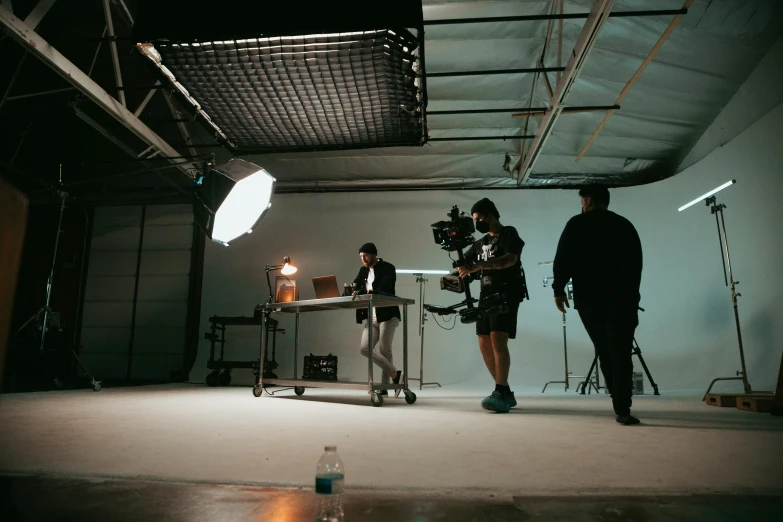 a man and woman standing in front of a camera