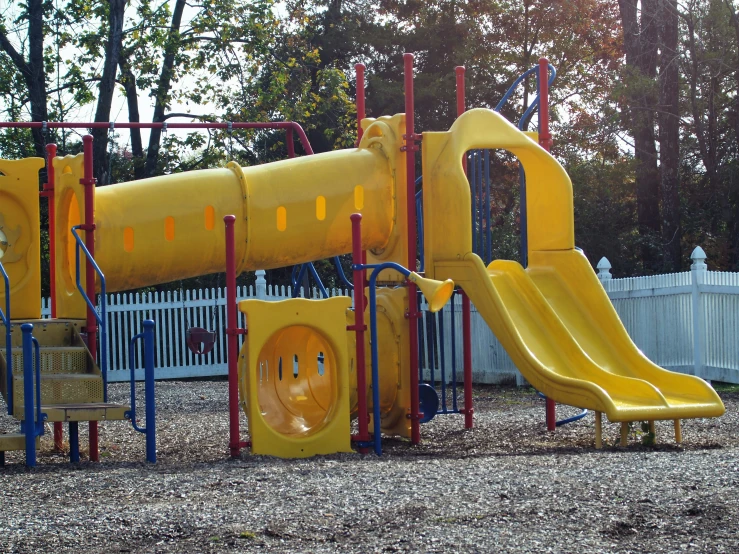 a yellow playground with a slide and other equipment