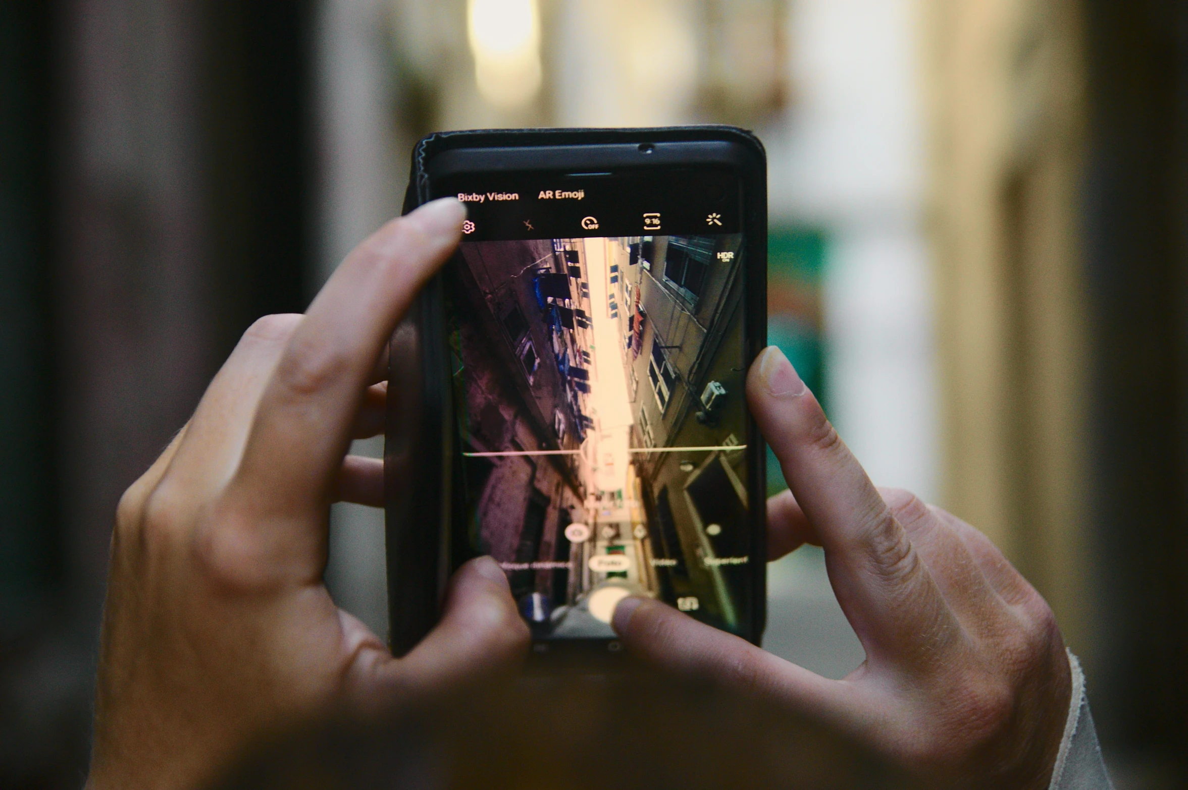 a woman holding up her smartphone to take a picture