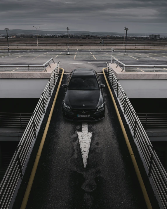 a black sports car is parked in a parking lot