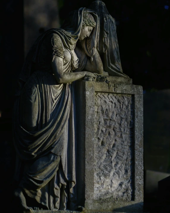 a sculpture of a woman covering her face and holding a purse