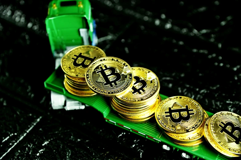 five bitcoin coins sitting in front of a green machine