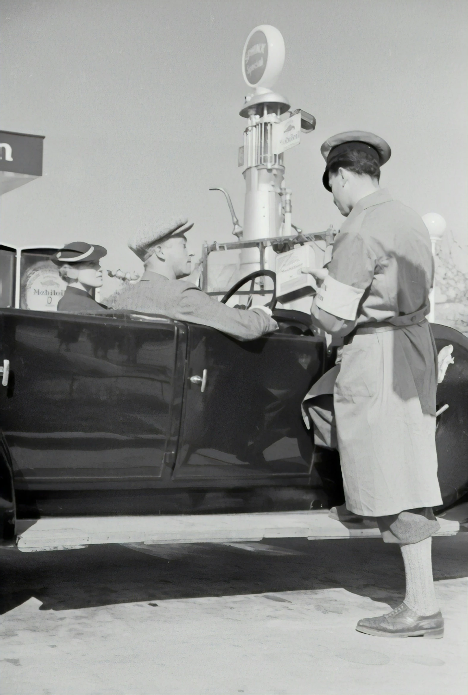 a vintage po of a man holding a baby inside of a car