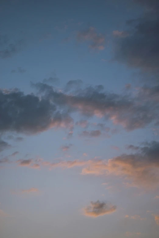 a plane is flying in the cloudy sky