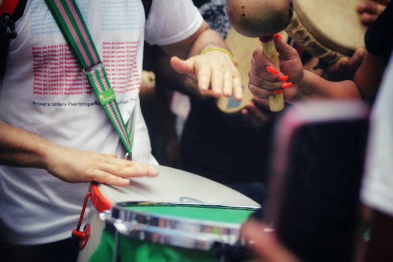 the people are watching as a man performs the musical instrument