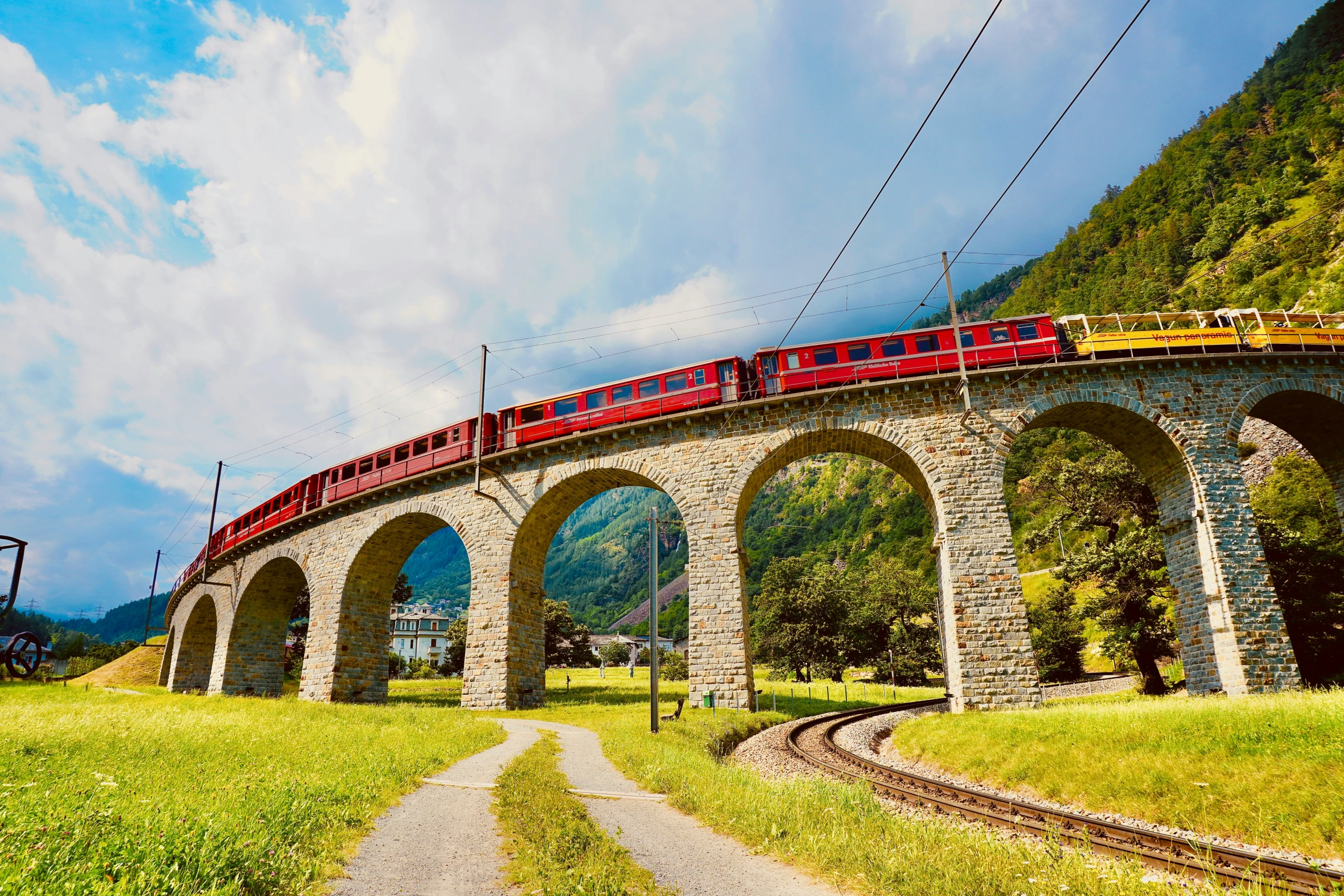 a long train traveling on top of a bridge