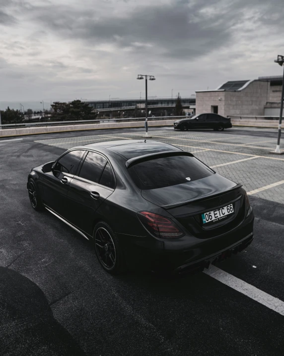 a black mercedes benz c63 in parking lot