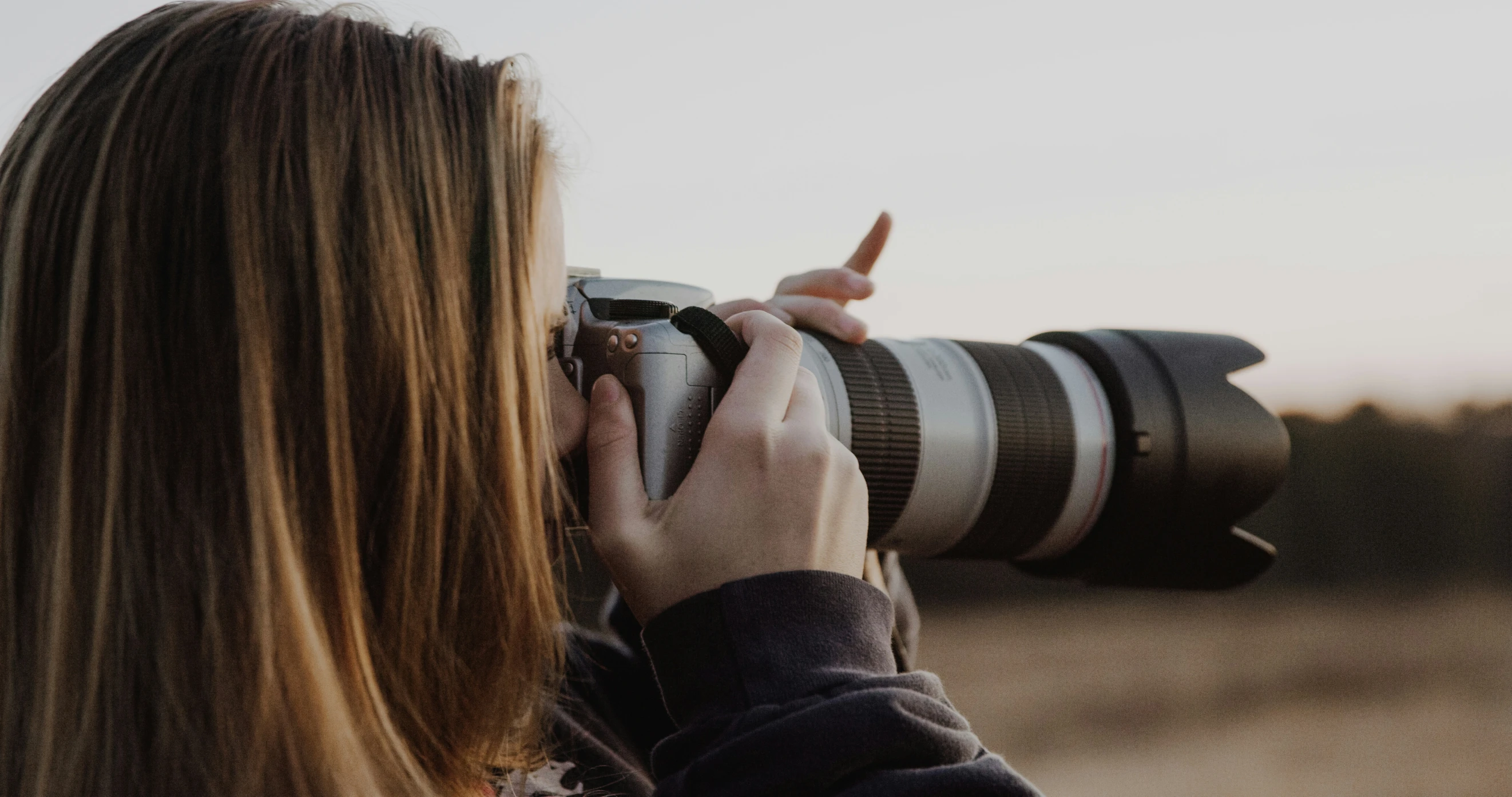 a person holding a camera in their hands and taking a picture