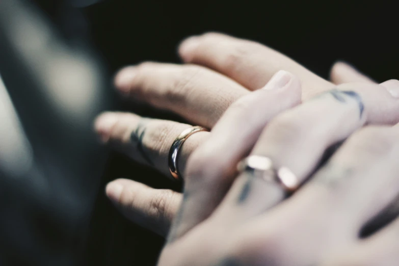 two people wearing rings and rings on their fingers