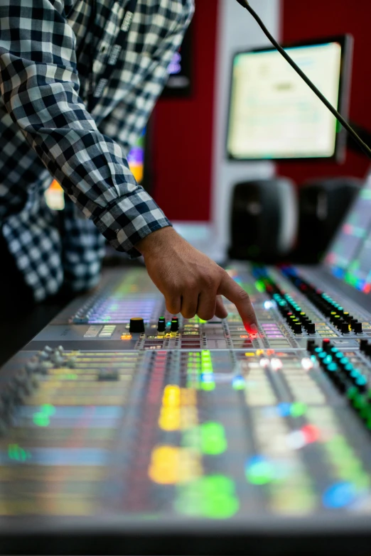 a man at a control room with electronic equipment