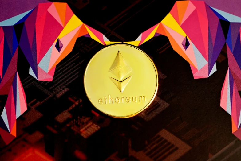the shiny, gold ethereum medallion is surrounded by colorful geometric shapes