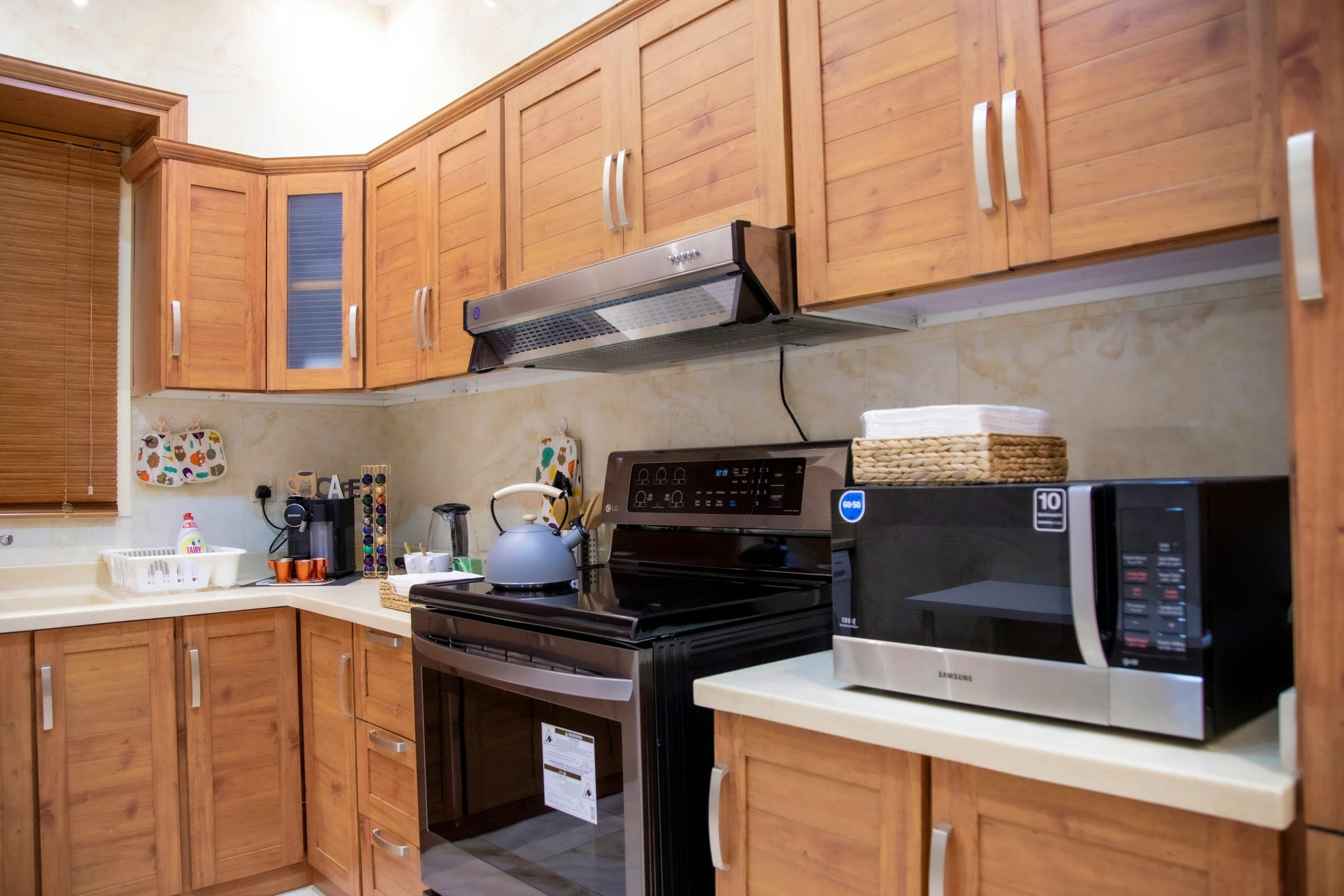 a kitchen filled with wooden cabinets and stainless steel appliances