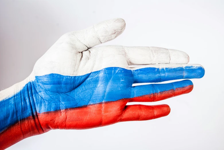 a hand with an russian flag painted on it