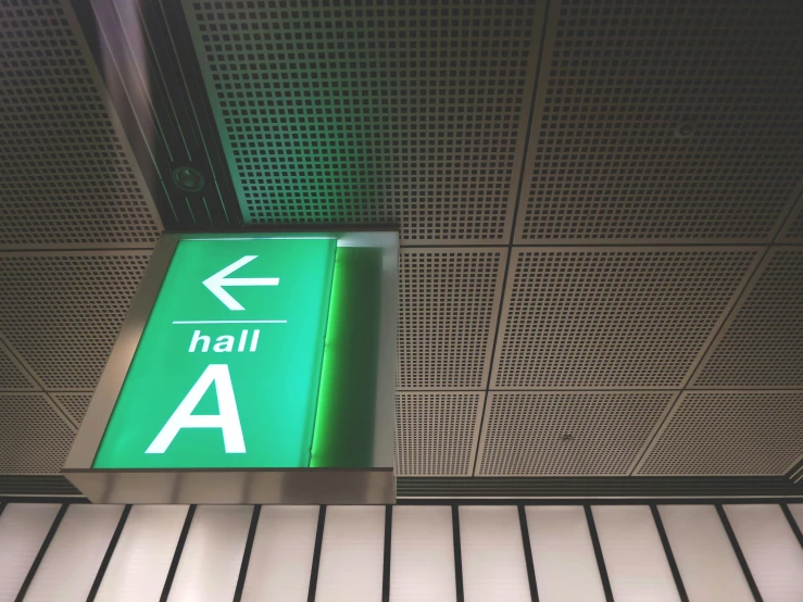 a green sign in a hallway indicates it is open