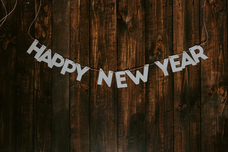 a birthday garland hanging from a wooden wall