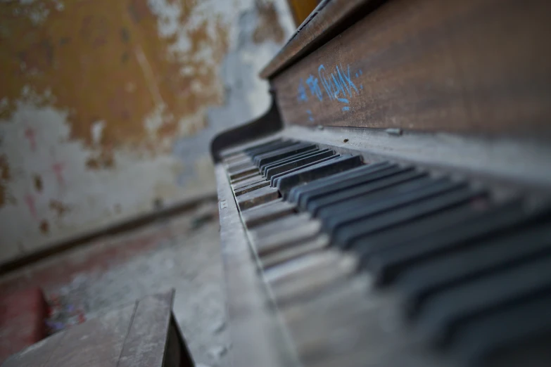 an old piano has some graffiti on it