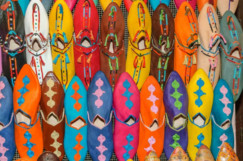 a group of colorful shoes are displayed on a rack