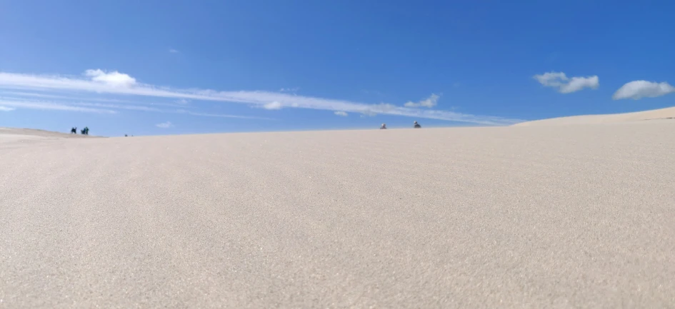 the sky above a sandy hill in a desert