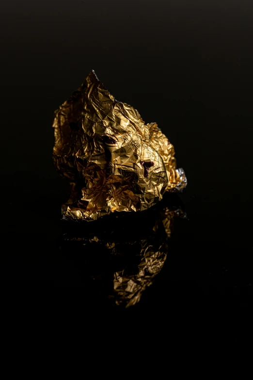 a piece of gold sitting on top of a table