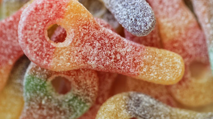 a pile of colorful powdered sugared donuts