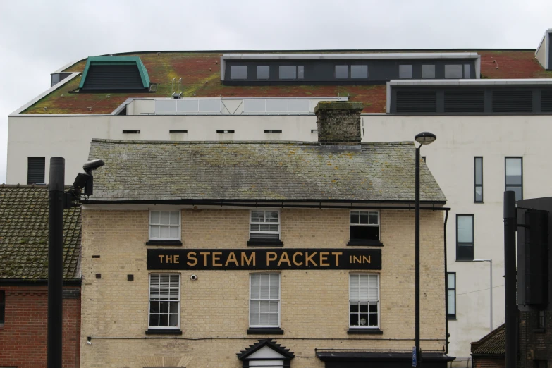 the steamer packet inn sign on the top of a yellow building