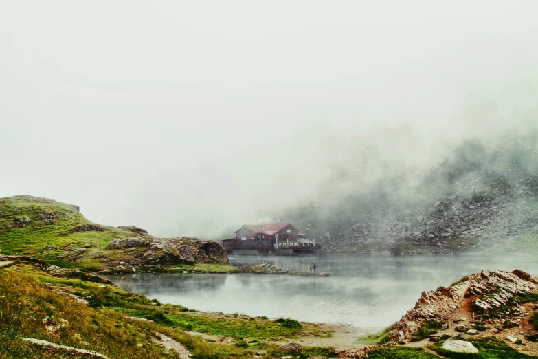 a house on a cliff near a lake