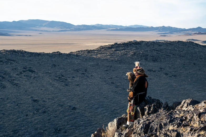 a man is walking in the mountains while on his cellphone