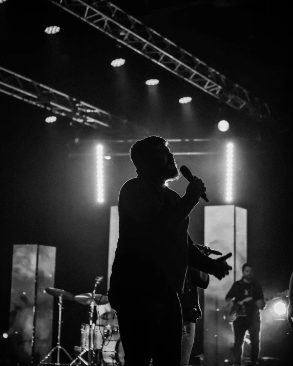 people playing instruments on stage at night