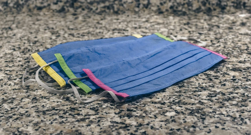 a blue pouch that has some colorful bands on it