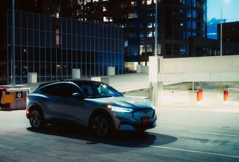 a grey car on a city street at night