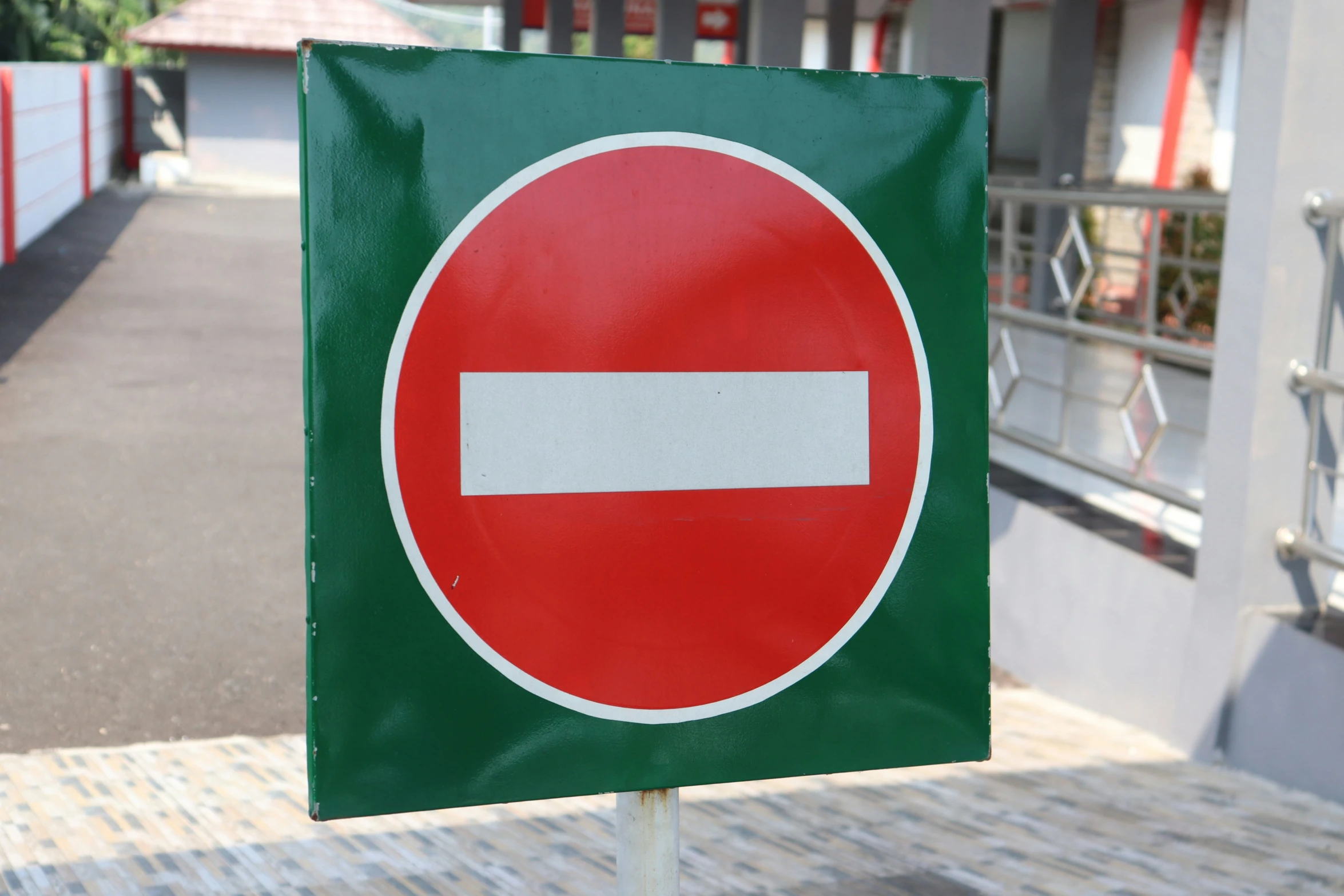 the green sign has a red white and black stripe