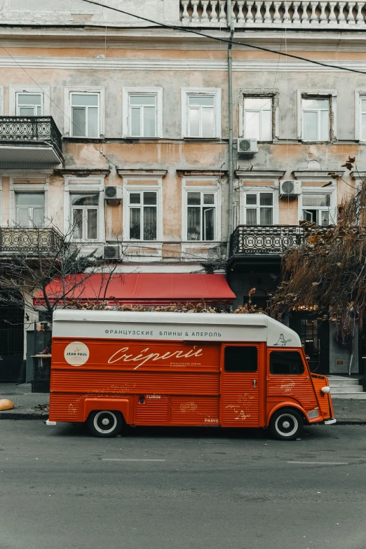 an old red van with a sign painted on the side