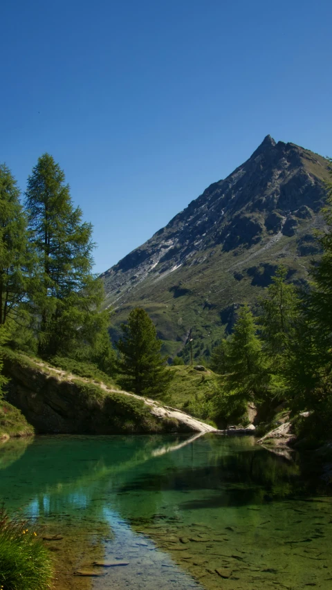 a body of water with a mountain in the background