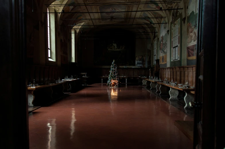 an empty room with wooden tables and benches