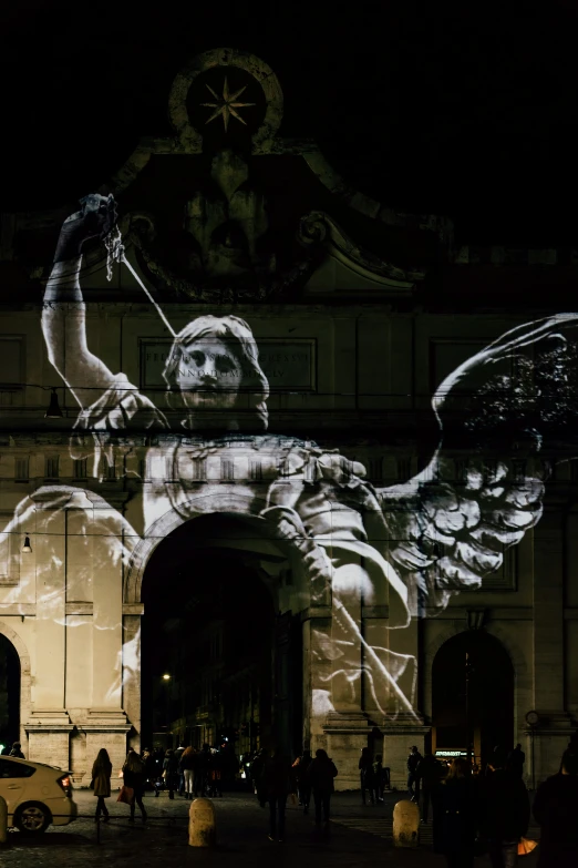 projected image on wall with people at night