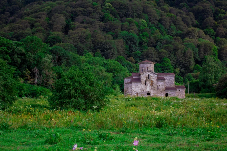 an old building standing alone in a forest